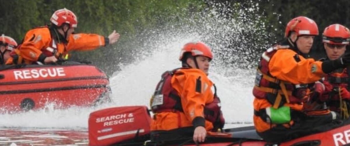 Search and rescue boat with staff trying to help resident